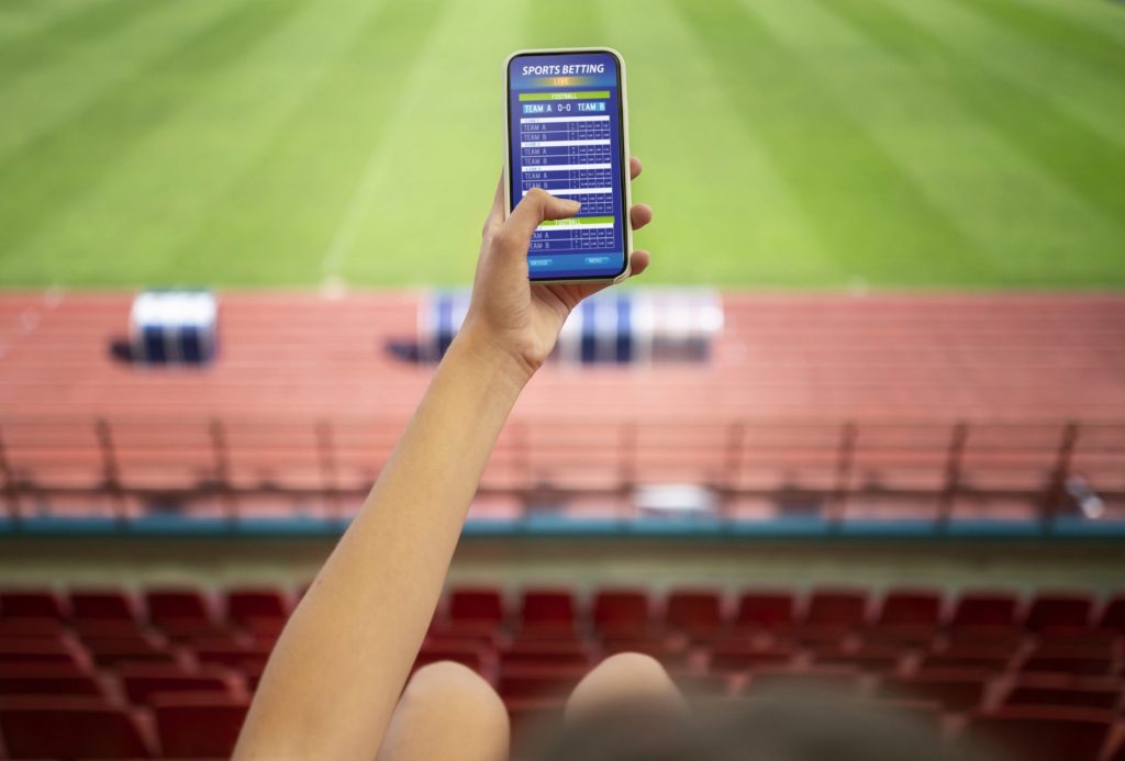 Understanding The Odds In Sports Betting 2 High Angle Hand Holding Smartphone